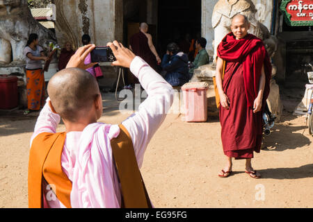 Buddhist nun in pink and monk in red robes photo at Gawdaw Palin,Gaw,Daw Gawdawpalin,Buddhist temple Pagan,Bagan Burma, Myanmar Stock Photo