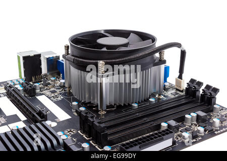 Computer motherboard isolated on white background with CPU cooler Stock Photo
