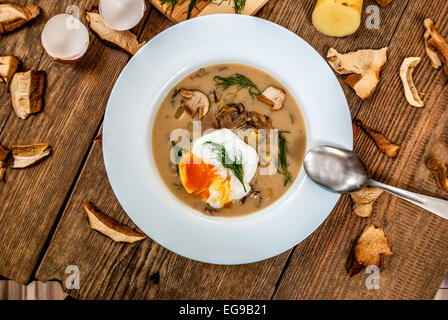 Czech traditional soup kulajda with dill and mushroom and poached egg Stock Photo