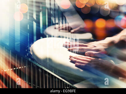 Street music background. Hands on percussion, abstract urban details and lights Stock Photo