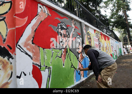 Dhaka, Bangladesh, 20th Feb, 2015. Bangladeshi fine arts student paints on the wall as part of the decoration for the International Mother Language Day celebration Stock Photo