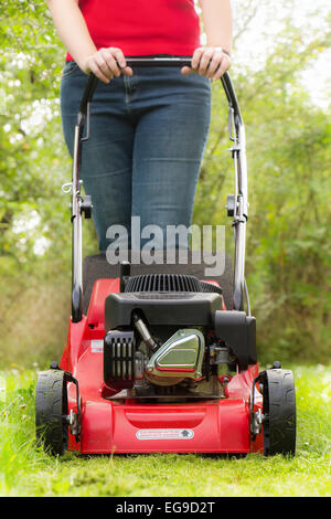 Lawn mowing with petrol lawn mower Stock Photo