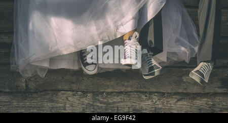 Low-section of newlyweds in canvas shoes Stock Photo