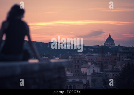 Italy, Rome, Woman starring roman sunset at Giardino degli Aranci Peak Stock Photo