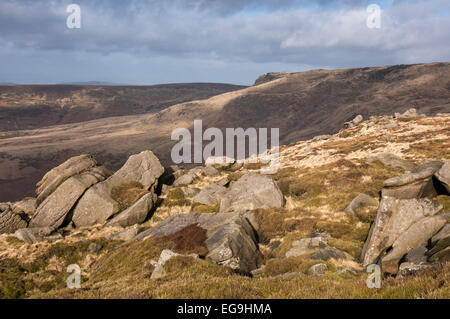 Gritstone rocks scattered across the moors below Kinder Scout. View towards Sandy Heys. Stock Photo
