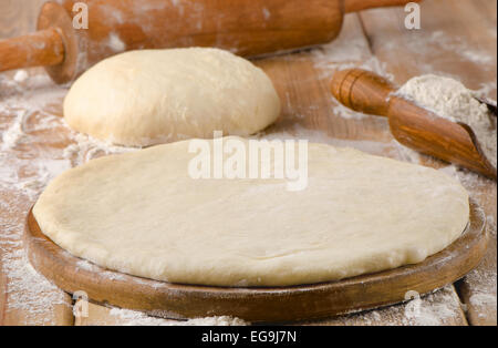 pizza dough on  wooden background. selective focus Stock Photo