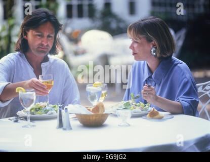 Adult couple having lunch in a restaurant courtyard. Stock Photo
