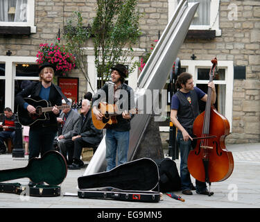 Band playing outdoors in the main square in Haworth, a popular tourist village in the heart of Bronte country in Yorkshire, UK. Stock Photo