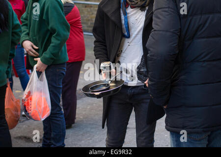 A man holding a frying pan with an attached Go Pro camera Stock Photo