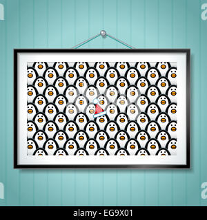 Single Penguin wearing Santa Hat in large Group Photo of Penguins in Picture Frame Hanging on Blue Wallpaper Background Stock Photo