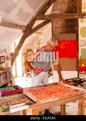 Artist Ed Buziak creating an abstract artwork with pastel crayons - France. Stock Photo