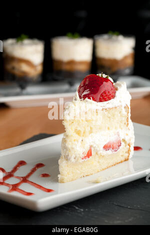 Strawberry shortcake with tea on a white porcelain plate Stock Photo ...