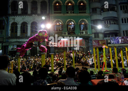 People watch a dragon dance during the annual Spring Festival Parade