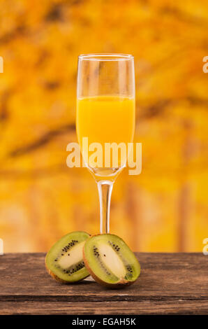 glass of juice with kiwi slices on a wooden table Stock Photo