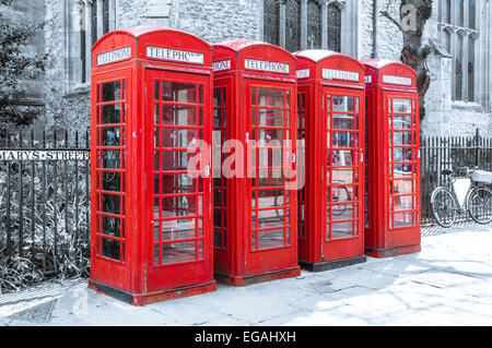 Row of red british telephone boxes on desaturated background Stock Photo