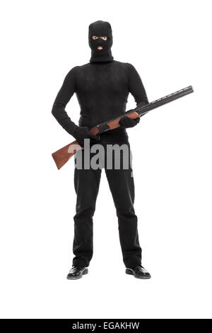 Full length portrait of a masked terrorist holding a shotgun isolated on white background Stock Photo