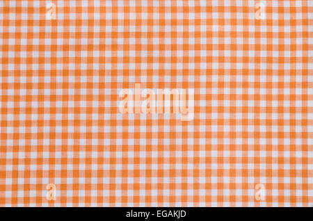 background of orange checkered fabric tablecloth Stock Photo