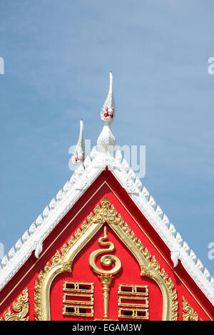 Red tile roof of temple Thailand on blue sky background. Stock Photo