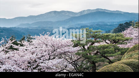 Kenroku-en, Kanazawa, one of the Three Great Gardens of Japan. The view of the mountains beyond the garden in springtime Stock Photo