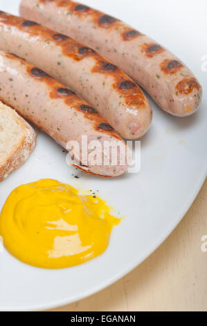 traditional fresh German wurstel sausages grilled with yellow mustard Stock Photo