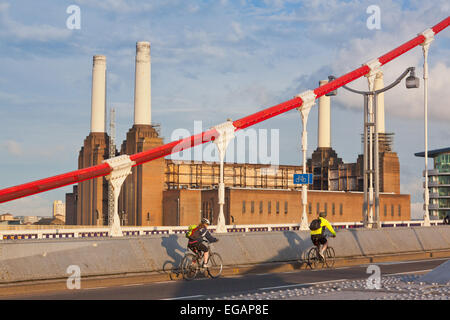 Cyclists on Chelsea Bridge with Battersea Power Station behind, London, England Stock Photo