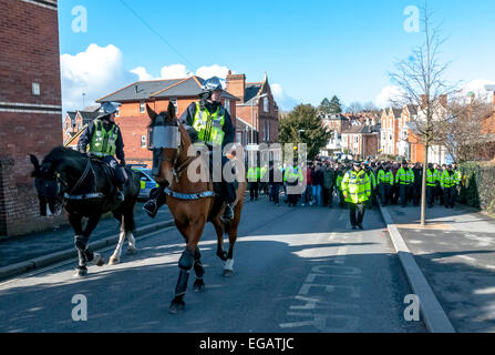Police horses escort Plymouth Argyle football fans along York Road during the police operation to prevent football violence at the League 2 football match between Exeter City FC and Plymouth Argyle FC on February 21st, 2015 in Exeter, Devon, UK Stock Photo