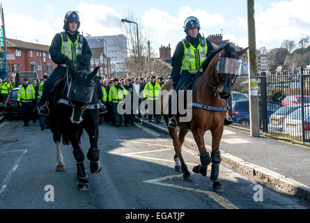 Police horses escort Plymouth Argyle football fans along Wells Street during the police operation to prevent football violence at the League 2 football match between Exeter City FC and Plymouth Argyle FC on February 21st, 2015 in Exeter, Devon, UK Stock Photo