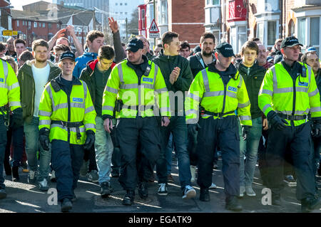 Devon and Cornwall Police escort Plymouth Argyle football fans along Wells Street during the police operation to prevent football violence at the League 2 football match between Exeter City FC and Plymouth Argyle FC on February 21st, 2015 in Exeter, Devon, UK Stock Photo