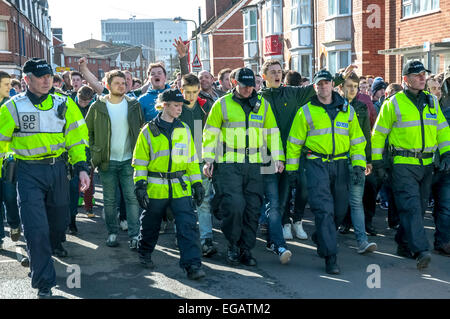 Devon and Cornwall Police escort  football fans along Wells Street during the police operation to prevent football violence at the League 2 football match between Exeter City FC and Plymouth Argyle FC on February 21st, 2015 in Exeter, Devon, UK Stock Photo