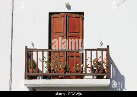 Typical white house with colored window in Mykonos island, Greece Stock Photo