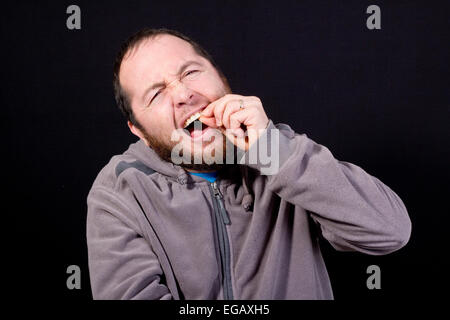 man with toothache isolated on black Stock Photo