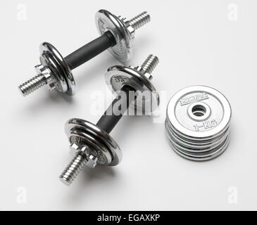 Dumbells and weight plates cut out isolated on white background Stock Photo
