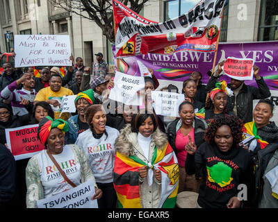 London, UK. 21 February, 2015. Activists outside the Zimbabwean Embassy dance and chant in protest against Mugabe on his 91st birthday. Credit:  Pete Maclaine/Alamy Live News Stock Photo