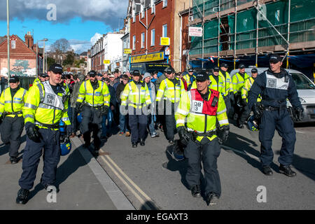 Devon and Cornwall Police escort Plymouth Argyle football fans away along Wells Street during the police operation to prevent football violence at the League 2 football match between Exeter City FC and Plymouth Argyle FC on February 21st, 2015 in Exeter, Devon, UK Stock Photo