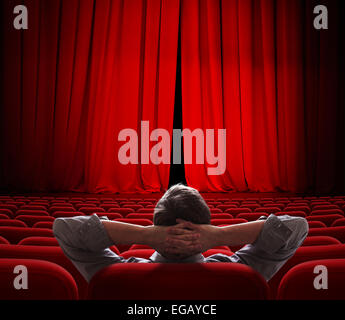 cinema screen red curtains slightly open for vip person Stock Photo