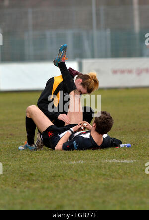 a physiotherapist attends to an injured rugby player in a match between broughton park and new brighton Stock Photo