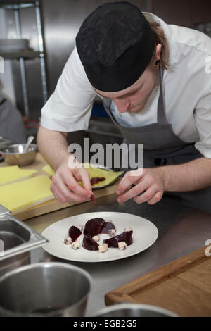 Chef in Kitchen preparing Cheese and Beetroot StarterDish at Sixty One Restaurant in London Stock Photo
