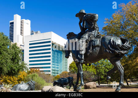 Cattle Drive sculptures with downtown skyline behind, Pioneer Plaza, Dallas, Texas, USA Stock Photo