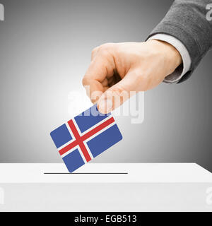 Voting concept - Male inserting flag into ballot box - Iceland Stock Photo