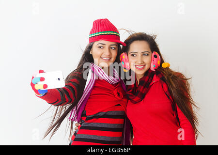 2 indian girls Winter Season phone selfie Stock Photo