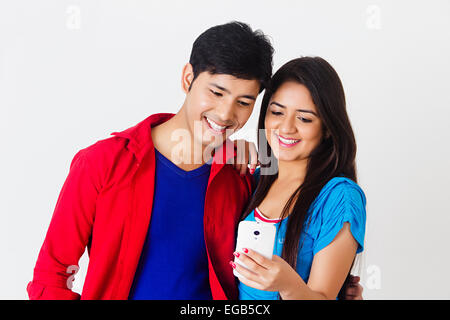 2 indian college couple chatting phone Stock Photo