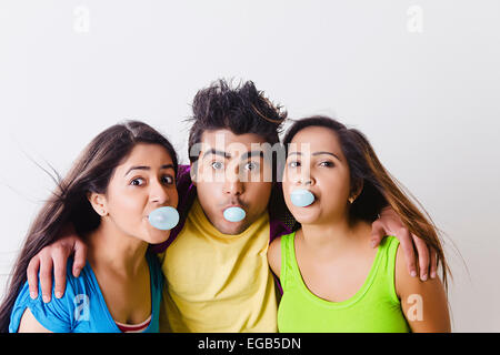 3 indian college friends Blowing Bubble Gum Stock Photo