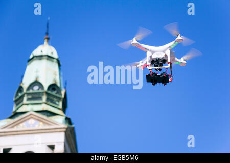 Radio controlled quadcopter drone flying in the blue sky Stock Photo