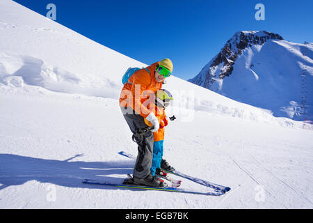 Instructor give ski lesson to little boy Stock Photo