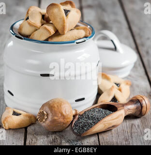 Hamantaschen cookies or Haman's ears - triangle cookies stuffed with poppy seeds, traditioal food on Purim, judaic holiday. Stock Photo