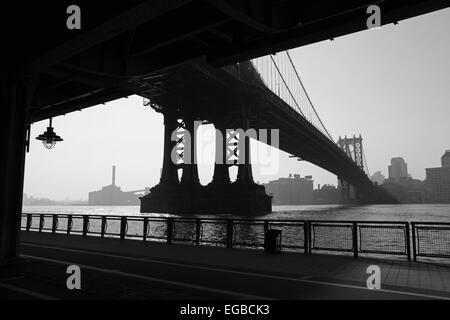 Manhattan Bridge spanning the East River to DUMBO Brooklyn in black and white. Stock Photo