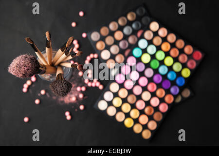 Palette of eyeshadows with brushes isolated on black background Stock Photo