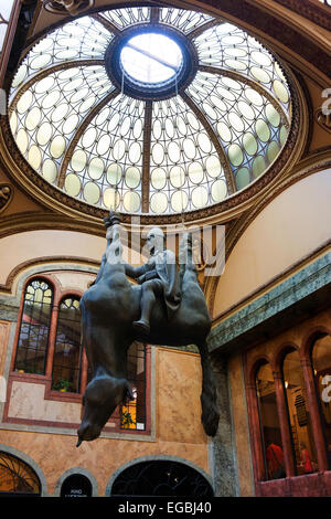 The shopping arcade and atrium in Lucerna Palace with David Cerny's sculpture Kun (Horse). Stock Photo