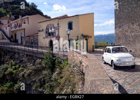 Classic Fiat 500 car driving on a road in Florence, Italy. Shot from ...