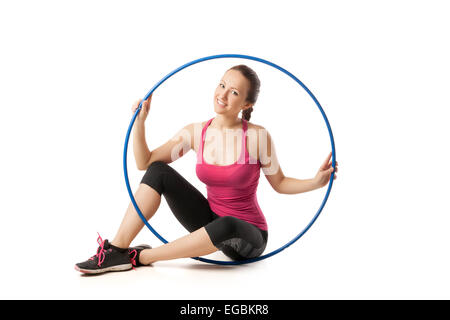 Beautiful woman sitting with color hula hoop Stock Photo